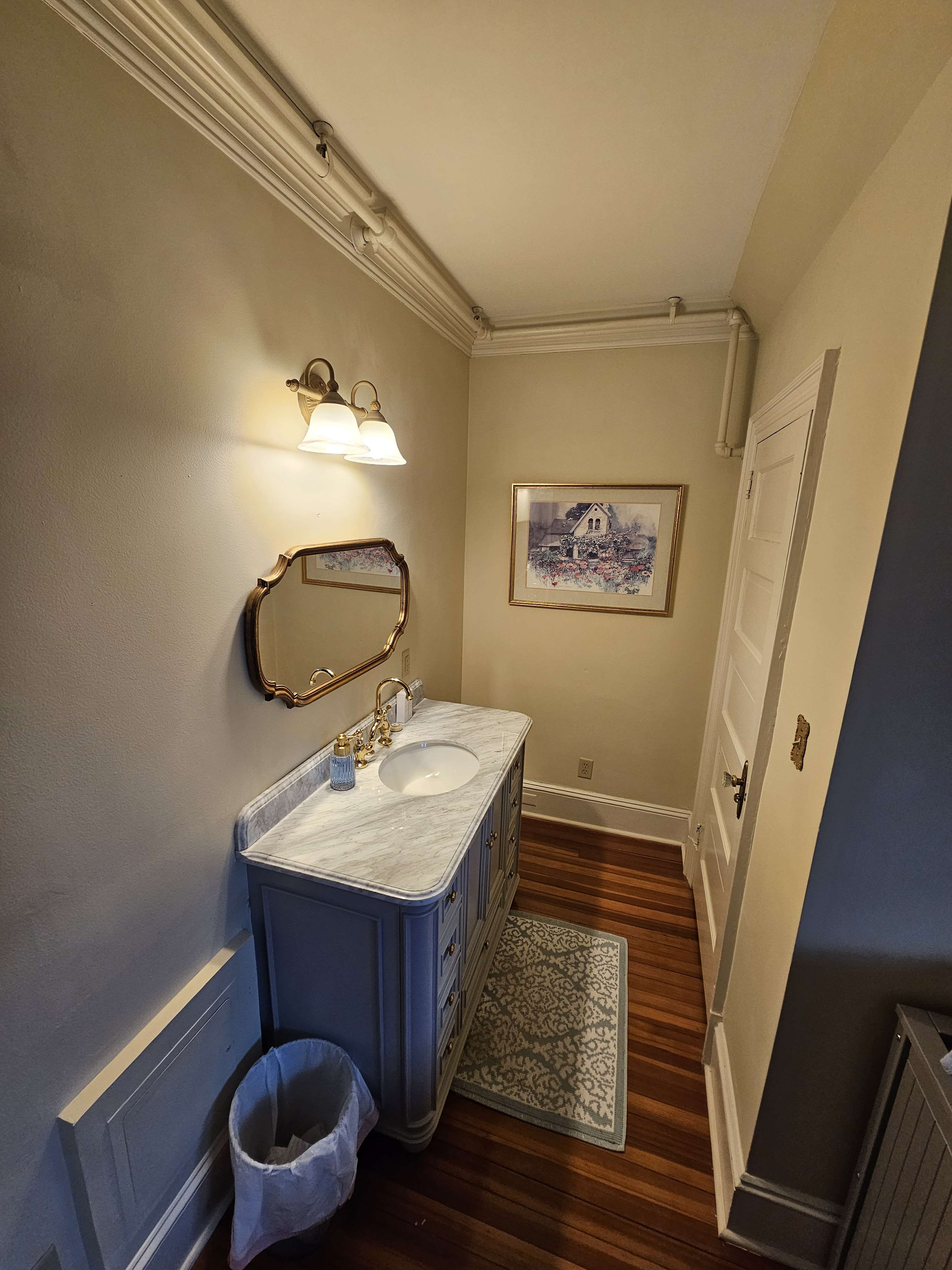 Sink area with wooden vanity in room